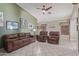 Comfortable living room features tile floors, neutral paint, and a ceiling fan at 12630 W Aster Dr, El Mirage, AZ 85335