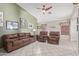 Comfortable living room features tile floors, neutral paint, and a ceiling fan at 12630 W Aster Dr, El Mirage, AZ 85335