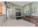 Inviting living space featuring tile flooring and neutral wall colors, adjacent to the kitchen and dining areas at 12630 W Aster Dr, El Mirage, AZ 85335
