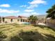 Expansive backyard featuring a well-maintained lawn, inviting pool, grilling area and desert landscaping at 1321 E Pedro Rd, Phoenix, AZ 85042