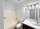 Clean bathroom featuring a shower-tub combo, modern fixtures, a glass bowl sink, and a neutral color palette at 1321 E Pedro Rd, Phoenix, AZ 85042