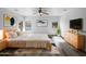 Inviting main bedroom featuring natural light, neutral walls, sleek wood-look floors, and a modern ceiling fan at 1321 E Pedro Rd, Phoenix, AZ 85042