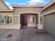 An inviting front entrance features a decorative door, stylish lighting, and neutral exterior color palette at 1321 E Pedro Rd, Phoenix, AZ 85042