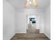 Hallway view to the kitchen featuring modern flooring, white walls, and open spaces at 1321 E Pedro Rd, Phoenix, AZ 85042