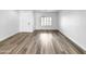 Spacious living room showcasing light wood flooring, neutral palette, a large window, and a bright, inviting atmosphere at 1321 E Pedro Rd, Phoenix, AZ 85042
