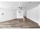 Large, open living room featuring neutral walls, wood-look flooring, modern lighting, and ample natural light at 1321 E Pedro Rd, Phoenix, AZ 85042