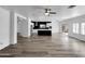 Bright living room with modern flooring, ceiling fans, and an open view to the kitchen at 1321 E Pedro Rd, Phoenix, AZ 85042