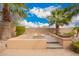 Backyard sitting area with built-in fire pit, brick pavers, lush landscaping and a desert view at 13344 W Via Caballo Blanco --, Peoria, AZ 85383