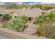 An aerial view of a home with mature palm trees and a built-in fire pit at 13344 W Via Caballo Blanco --, Peoria, AZ 85383