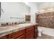 Bathroom features an extended vanity, a tub/shower combo, and tile accents at 13344 W Via Caballo Blanco --, Peoria, AZ 85383