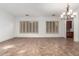 Inviting living room with plantation shutters, a view to the butler's pantry, and neutral colors at 13344 W Via Caballo Blanco --, Peoria, AZ 85383