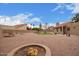 Large backyard featuring desert landscaping, a fire pit, and artificial turf at 1365 N El Dorado Dr, Chandler, AZ 85224