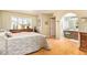 Light-filled bedroom with hardwood floors, shutters, and an ensuite bath at 1365 N El Dorado Dr, Chandler, AZ 85224