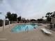 Inviting community pool surrounded by lounge chairs and lush landscaping at 1365 N El Dorado Dr, Chandler, AZ 85224