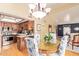 Dining room with kitchen view, wood floors, chandelier, and seating for four at 1365 N El Dorado Dr, Chandler, AZ 85224