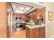 Modern kitchen featuring stainless steel appliances, wood cabinets, and tiled backsplash at 1365 N El Dorado Dr, Chandler, AZ 85224