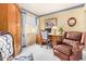 Home office featuring a wooden desk, comfortable chair, and window with blinds at 1365 N El Dorado Dr, Chandler, AZ 85224