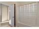 Bathroom featuring a shower with translucent curtain and a view into another room at 13672 W Chaparosa Way, Peoria, AZ 85383