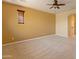 Bright and airy bedroom featuring carpet, neutral walls, and a ceiling fan at 13672 W Chaparosa Way, Peoria, AZ 85383