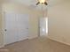 Bedroom with carpet, neutral walls, a ceiling fan, and large closet at 13672 W Chaparosa Way, Peoria, AZ 85383