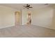 A bedroom with carpet adjacent to a bathroom with tiled floors and a large soaking tub at 13672 W Chaparosa Way, Peoria, AZ 85383