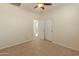 Bedroom with carpet, fan, double closets, and view into the hall at 13672 W Chaparosa Way, Peoria, AZ 85383