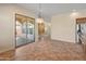 Dining area with a sliding door providing access to the covered patio and views of the backyard at 13672 W Chaparosa Way, Peoria, AZ 85383