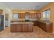 Open kitchen featuring granite countertops, a central island, and stainless steel appliances at 13672 W Chaparosa Way, Peoria, AZ 85383
