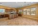 Well-lit kitchen featuring a granite island, plentiful cabinet space, and modern stainless steel appliances at 13672 W Chaparosa Way, Peoria, AZ 85383