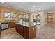 Bright, large kitchen with granite counters, stainless steel appliances, and an island with seating at 13672 W Chaparosa Way, Peoria, AZ 85383