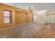Bright living room with carpet, tile, wooden blinds, and a staircase leading to the second floor at 13672 W Chaparosa Way, Peoria, AZ 85383