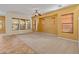 Expansive living room featuring neutral walls, plush carpeting, and large windows with wood-like blinds at 13672 W Chaparosa Way, Peoria, AZ 85383