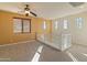 Spacious loft area boasts carpet flooring, natural light, and a ceiling fan at 13672 W Chaparosa Way, Peoria, AZ 85383