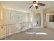 Upstairs loft with lots of natural light, a ceiling fan, and carpet flooring at 13672 W Chaparosa Way, Peoria, AZ 85383