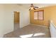 Loft offers a versatile space with carpet flooring, ceiling fan, and a view to the adjoining room at 13672 W Chaparosa Way, Peoria, AZ 85383