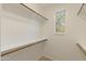 Walk-in closet featuring custom shelving for optimal storage and natural light from a window at 13672 W Chaparosa Way, Peoria, AZ 85383