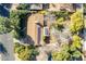 Aerial view of a home featuring a well-maintained roof, mature trees, and a serene neighborhood setting at 1410 W Berridge Ln, Phoenix, AZ 85013