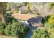 Aerial view of a home surrounded by mature trees and lush greenery, showcasing a private residential property at 1410 W Berridge Ln, Phoenix, AZ 85013