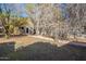 Exterior view of the rear outbuilding in the backyard with a pathway to its door at 1410 W Berridge Ln, Phoenix, AZ 85013