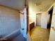 Bright bathroom featuring a shower-tub combination and tile flooring leading to a vanity area at 1606 E Cactus Wren Dr, Phoenix, AZ 85020
