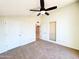 This bedroom features a ceiling fan and two doors at 1606 E Cactus Wren Dr, Phoenix, AZ 85020