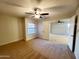 Standard carpeted bedroom with a ceiling fan and a window at 1606 E Cactus Wren Dr, Phoenix, AZ 85020
