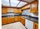 Kitchen featuring wood cabinets, neutral countertops and white appliances at 1606 E Cactus Wren Dr, Phoenix, AZ 85020