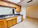 Kitchen with stainless steel sink and white dishwasher overlooking living area at 1606 E Cactus Wren Dr, Phoenix, AZ 85020