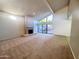 Open living room with vaulted ceilings, a fireplace, and sliding glass doors to the patio at 1606 E Cactus Wren Dr, Phoenix, AZ 85020