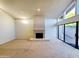 Open living room with large windows, a fireplace, and access to the backyard at 1606 E Cactus Wren Dr, Phoenix, AZ 85020