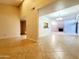 Spacious living room with tile flooring and a pass-through to the kitchen at 1606 E Cactus Wren Dr, Phoenix, AZ 85020