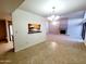 Open concept living room with fireplace and view into the kitchen at 1606 E Cactus Wren Dr, Phoenix, AZ 85020