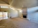 Light-filled living room featuring vaulted ceilings, a fireplace and outdoor access at 1606 E Cactus Wren Dr, Phoenix, AZ 85020