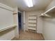 This walk-in closet features rods, shelves, and carpet flooring at 1606 E Cactus Wren Dr, Phoenix, AZ 85020